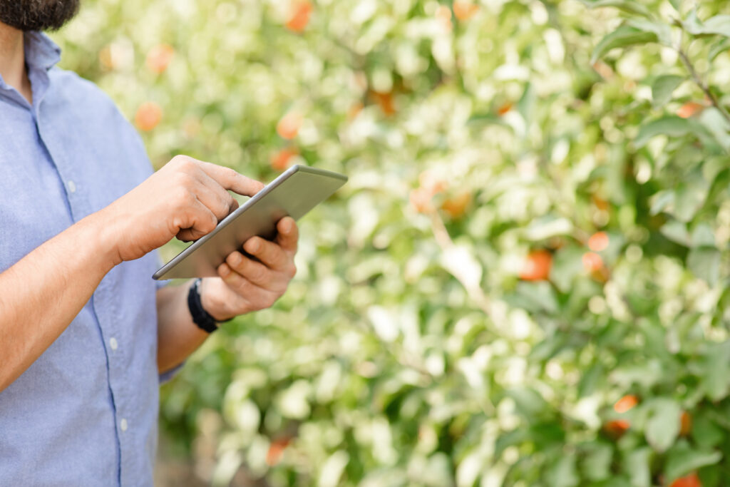 Modern tech with mobile app for working online in eco garden